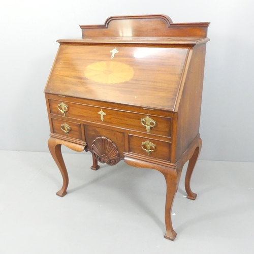 2146 - An early 20th century mahogany bureau, with inlaid shell decoration, the fall front revealing a fitt... 