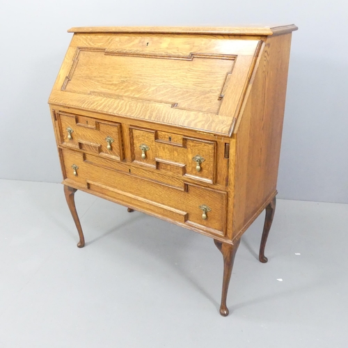 2147 - An oak Jacobean style bureau, the fall front revealing a fitted interior with two short and one long... 