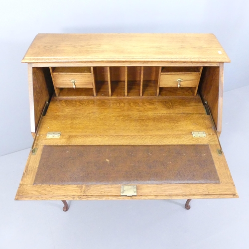 2147 - An oak Jacobean style bureau, the fall front revealing a fitted interior with two short and one long... 