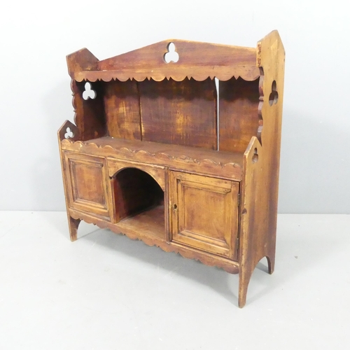 2153 - A rustic French pine table-top cabinet, with pierced trefoil decoration and two panelled doors. 62x6... 