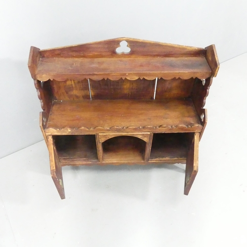 2153 - A rustic French pine table-top cabinet, with pierced trefoil decoration and two panelled doors. 62x6... 