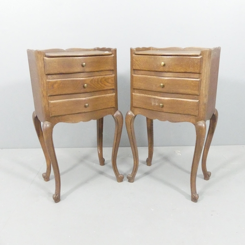 2156 - A pair of French oak three-drawer bedside tables with cabriole legs. 74x74x29cm.