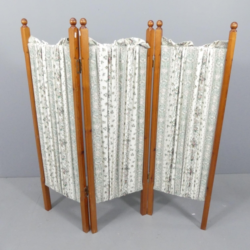 2166 - A pine and upholstered three-fold room divider screen. Each panel 45x140cm.