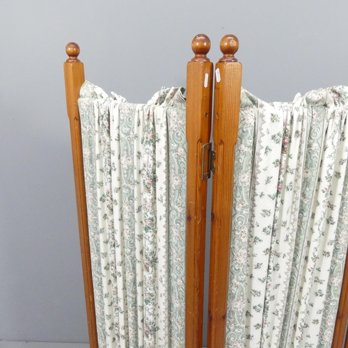 2166 - A pine and upholstered three-fold room divider screen. Each panel 45x140cm.