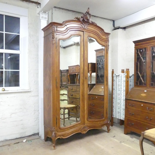 2167 - A French kingwood veneered arch-top armoire, with two mirror doors, shelf fitted interior and applie... 