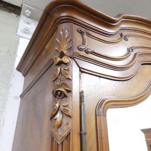 2167 - A French kingwood veneered arch-top armoire, with two mirror doors, shelf fitted interior and applie... 