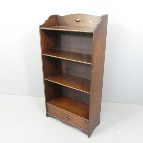 2175 - A 1930s oak open bookcase, with fixed shelves and drawers under. 60x120x26cm.