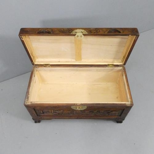 2182 - A small Chinese camphorwood blanket box, with all-over carved decoration. 69x38x33cm.