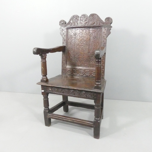 2188 - A late 18th / early 19th century joined oak Wainscot chair. Overall 66x112x53cm, seat 48x48x36cm.