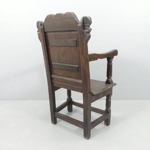 2188 - A late 18th / early 19th century joined oak Wainscot chair. Overall 66x112x53cm, seat 48x48x36cm.