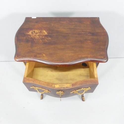 2189 - A continental style mahogany bedside chest of two drawers, with brass mounts and raised on cabriole ... 