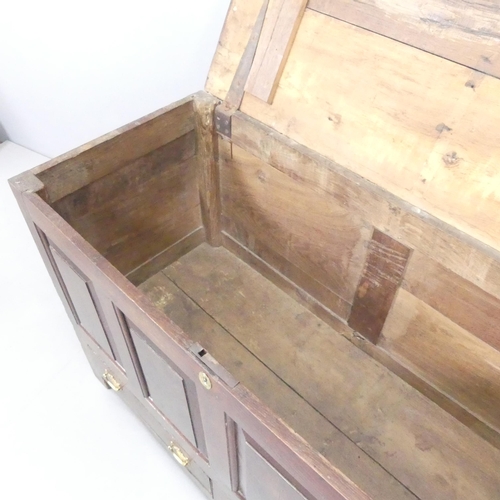 2201 - An 18th century panelled oak mule chest. 130x84x55cm.