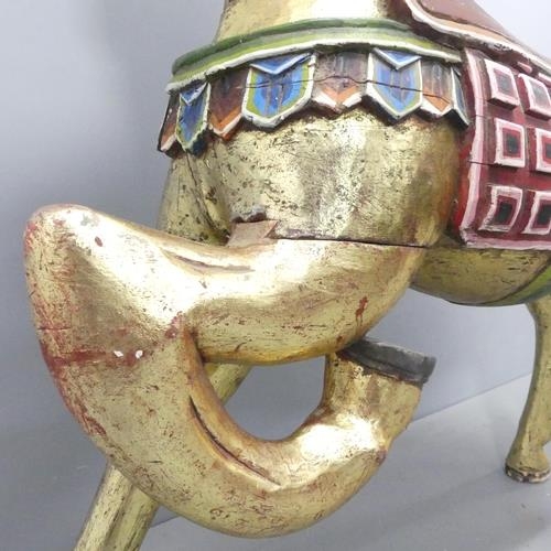 2051 - An Indonesian hand painted and gilded wooden horse. 137x132x44cm.