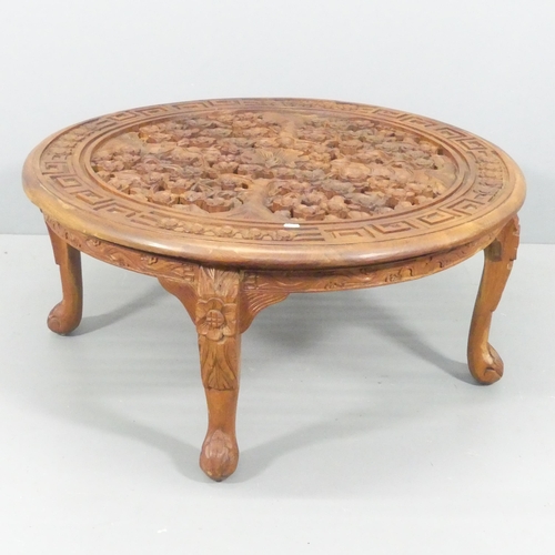 2212 - An oriental hardwood circular-topped coffee table, with carved and pierced decoration and cabriole l... 