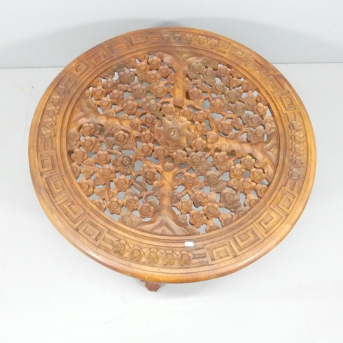 2212 - An oriental hardwood circular-topped coffee table, with carved and pierced decoration and cabriole l... 