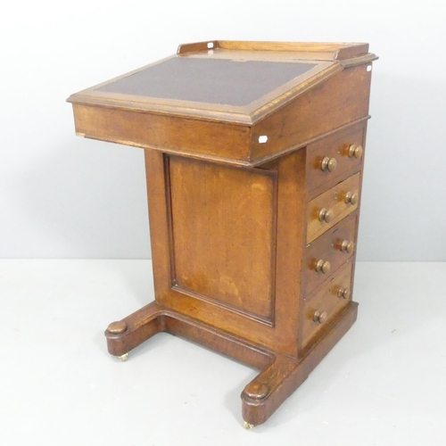 2214 - An antique oak davenport, with rising back, sliding front and two side drawers. Dimensions (stowed) ... 