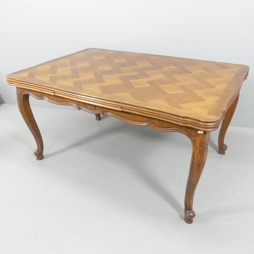 2219 - A French oak parquetry-top draw-leaf dining table. 150 (extending to 250cm) x76x100cm