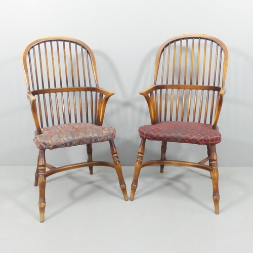 2221 - A pair of bow-arm Windsor kitchen elbow chairs, with upholstered seats and crinoline stretchers.