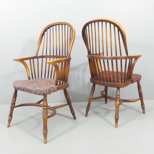 2221 - A pair of bow-arm Windsor kitchen elbow chairs, with upholstered seats and crinoline stretchers.