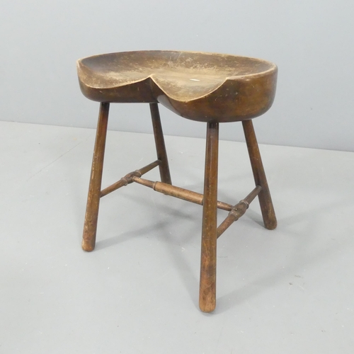 2253 - A vintage oak tractor-seat stool. Height 46cm.