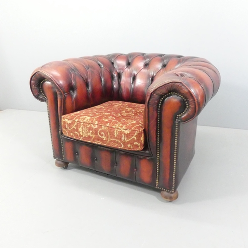 2264 - A red button-back studded leather upholstered Chesterfield style armchair. Overall 103x70x90cm, seat... 