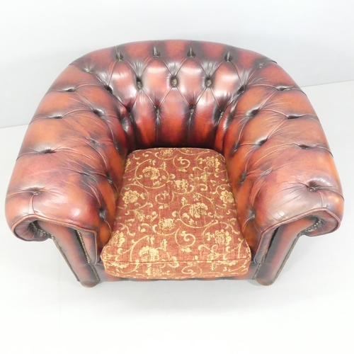 2264 - A red button-back studded leather upholstered Chesterfield style armchair. Overall 103x70x90cm, seat... 