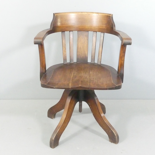 2270 - An early 20th century oak swivel desk chair.