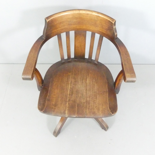 2270 - An early 20th century oak swivel desk chair.