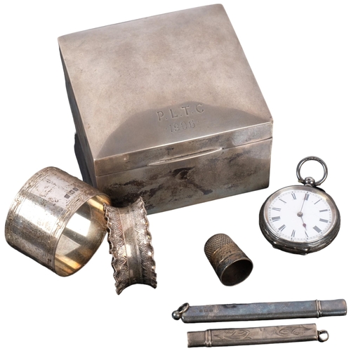 1092 - A square silver cigarette box, silver napkin rings, fob watch, etc