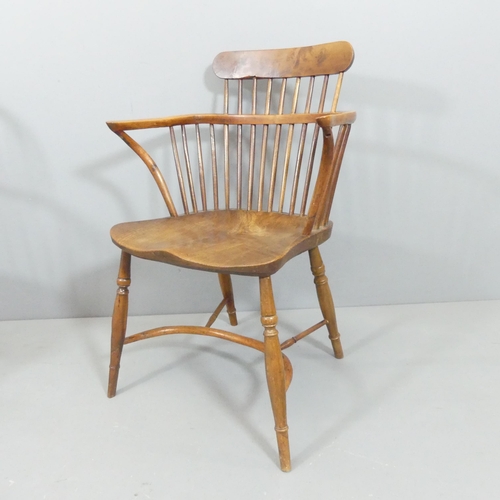 2271 - A yew-wood and elm-seated comb back Windsor bow arm chair, with crinoline stretcher.