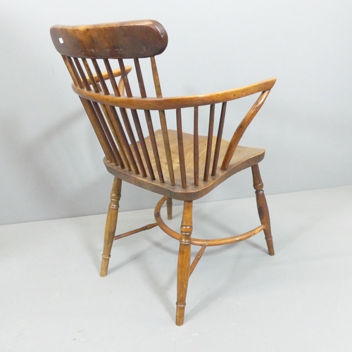 2271 - A yew-wood and elm-seated comb back Windsor bow arm chair, with crinoline stretcher.