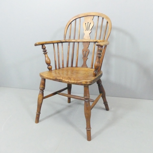 2272 - An antique elm seated Windsor open arm chair.