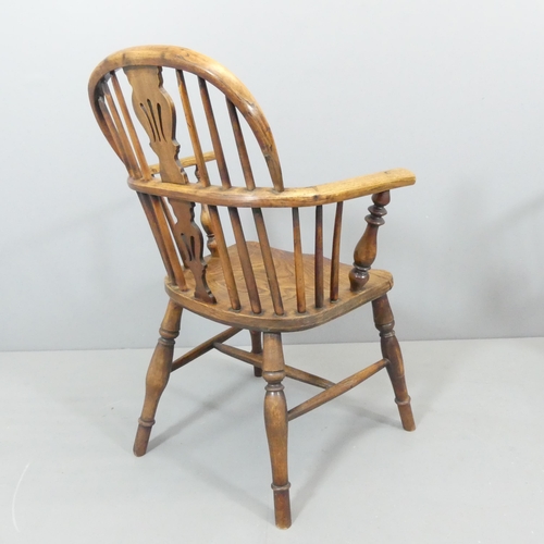 2272 - An antique elm seated Windsor open arm chair.