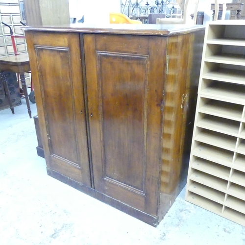 2561 - A pitch pine two-door cabinet fitted with twenty filing drawers. 112x123x65cm.