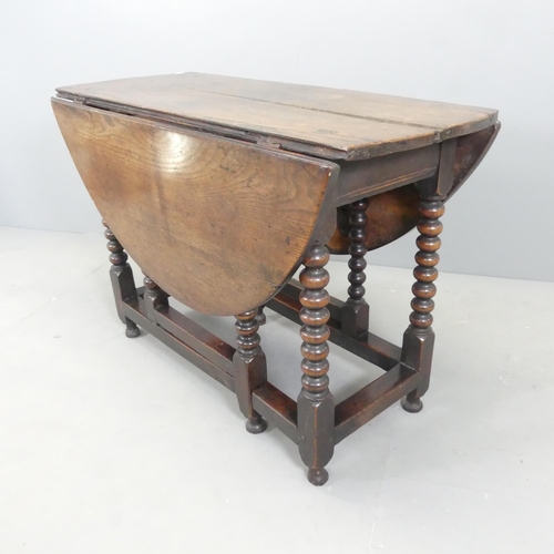 2573 - An antique oak oval gate-leg table, with bobbin turned legs. 106x73x43cm (opening to 125cm).