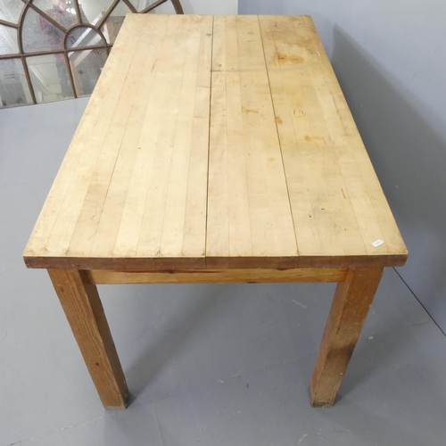 2581 - A maple plank-top table with label for Wood Welded West, Michigan, on pitch pine base. 137x76x78cm.