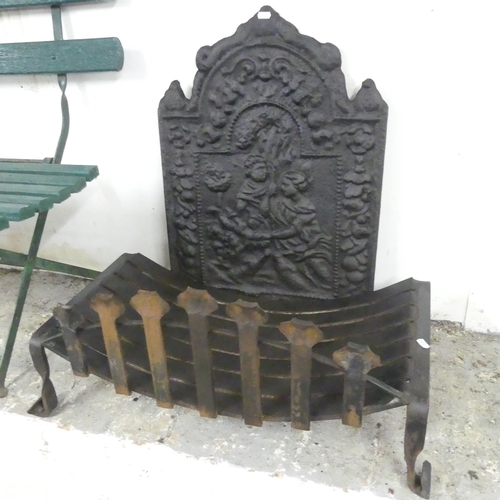 2602 - A cast iron fire back, 49x70cm, and a fire grate. (2)