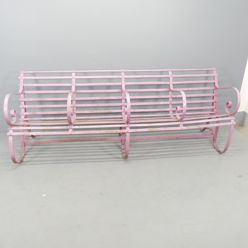 2604 - A Victorian strap iron four-seater garden bench with scrolled armrests. Overall 215x81x64cm, each se... 