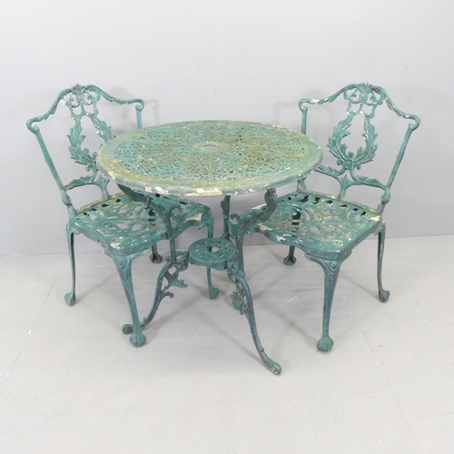 2609 - A painted cast aluminium circular garden table, 69x69cm, and two matching chairs.