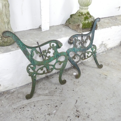 2617 - A pair of painted cast iron bench ends, with leopard head terminals. Height 74cm.