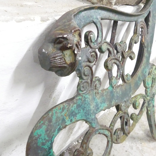 2617 - A pair of painted cast iron bench ends, with leopard head terminals. Height 74cm.