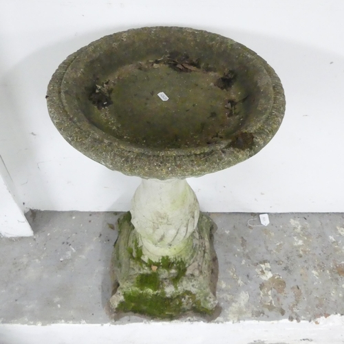 2618 - A two-section weathered concrete birdbath. Height 79cm.