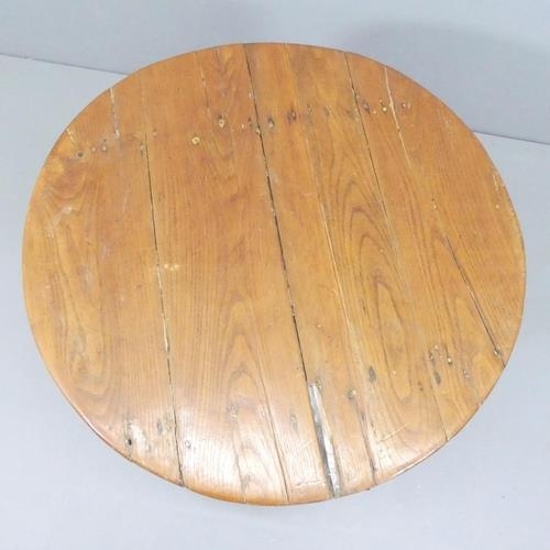 2623 - A French oak tilt-top wine table. 81x66cm.