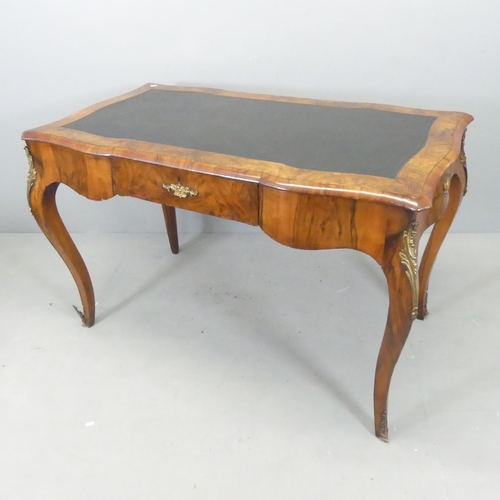 2627 - A French walnut veneered writing table, with tooled black leather skiver, single drawer and brass or... 