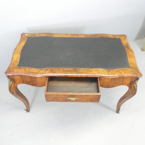 2627 - A French walnut veneered writing table, with tooled black leather skiver, single drawer and brass or... 