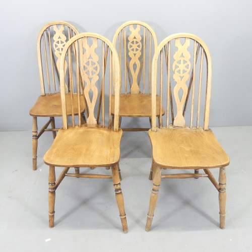 2640 - A set of four elm-seated wheel back dining chairs.