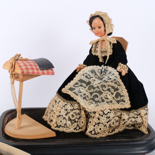 802 - A doll in lacework costume, under glass dome on plinth, and a box of lace worker's bobbins