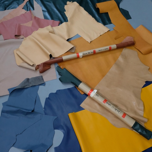 815 - Rolls of various coloured leather, widest 108cm