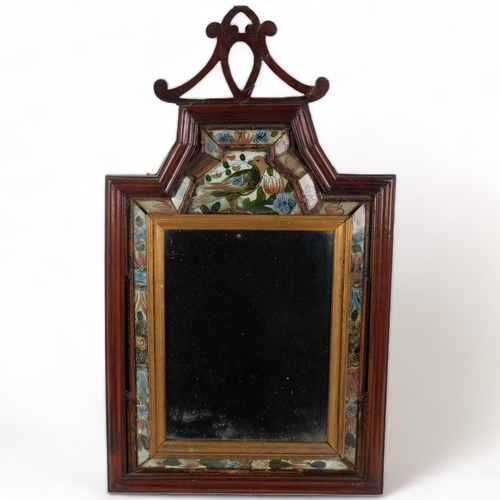 123 - A 19th Century mahogany-framed courting mirror, with a floral and bird painted glass cushion surroun... 