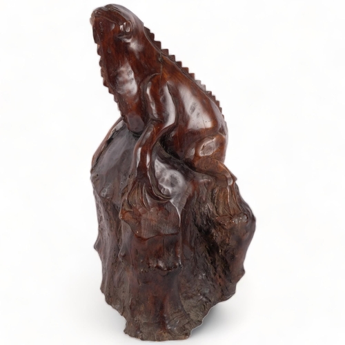 146 - A large carved hardwood study of a iguana climbing a tree stump, H56cm